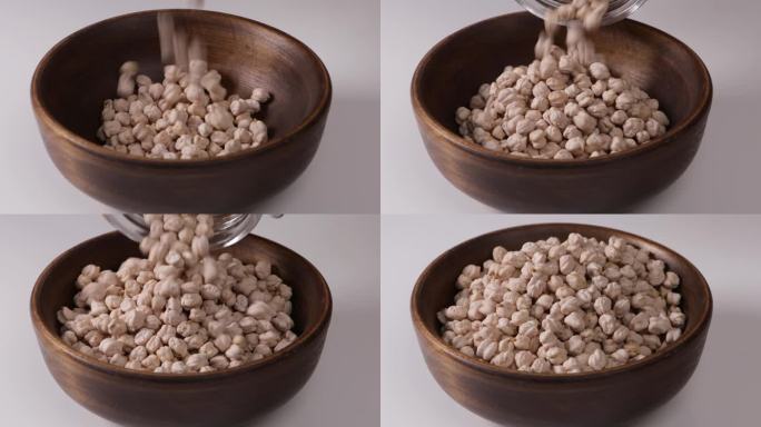 生的鹰嘴豆从罐子里掉到碗里，吃素