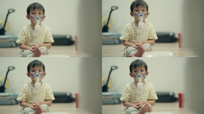 儿科保健:患病的亚洲男孩使用雾化器缓解流感和支气管炎。
