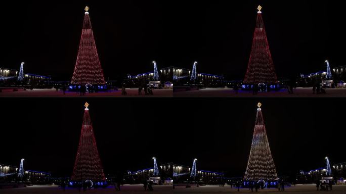 一棵又大又漂亮的新年树挂满了彩灯和装饰品，矗立在城市广场上。许多人晚上在街上庆祝新年。文本复制空间