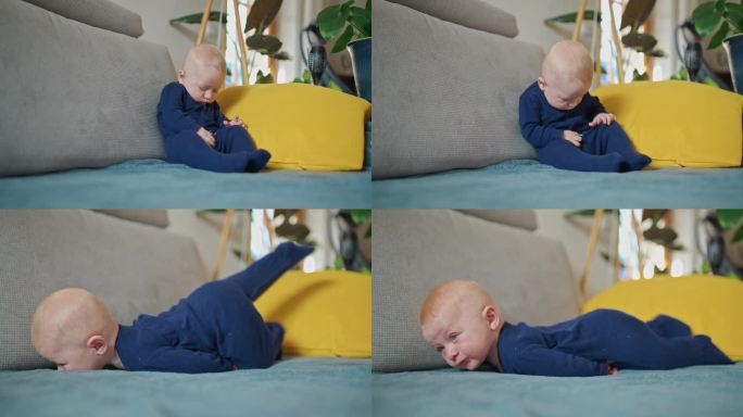 睡意朦胧的小男孩穿着蓝色天鹅绒紧身衣倒在家里的沙发上