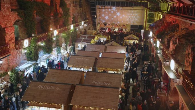 高角度手持拍摄的人群在圣诞市场夜间在格拉茨，施蒂里亚地区，奥地利