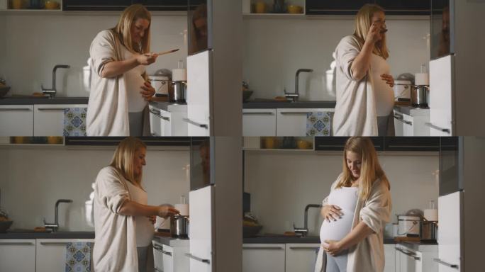 孕妇在家里厨房的炉子上品尝酱汁