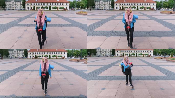 一名旅游女孩在欧洲城市散步时，拿着反光镜相机拍照