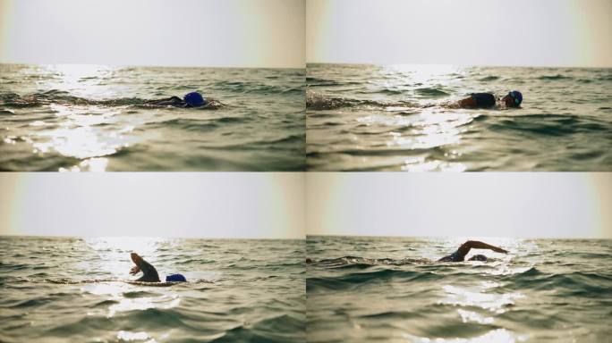 SLO MO TS女游泳运动员在阳光下游泳前爬泳。开放水域游泳者