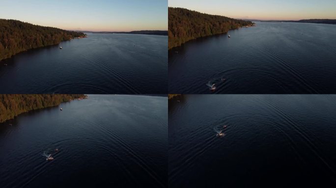 日落时分在华盛顿湖上划船的鸟瞰图，背景是雷尼尔山