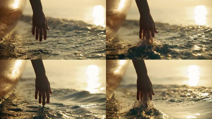 SLO MO优雅的飞溅:在日落航行时，一只手触摸水面