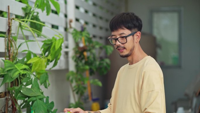 男人在家里用爱和关注浇灌盆栽植物。