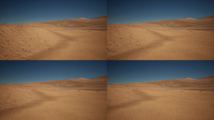 广阔的沙漠远景，以黄色的沙子为背景，深蓝色的天空。