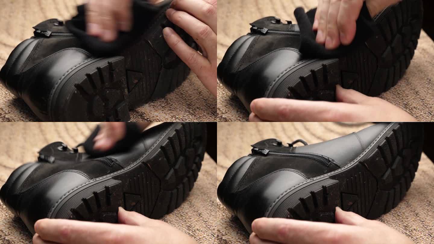 黑色皮靴上的脏东西要用毛布擦干净。鞋子护理的概念。