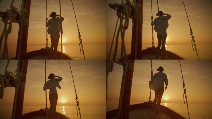 SLO MO航行宁静:一名女子在帆船上欣赏黄金时间的日落