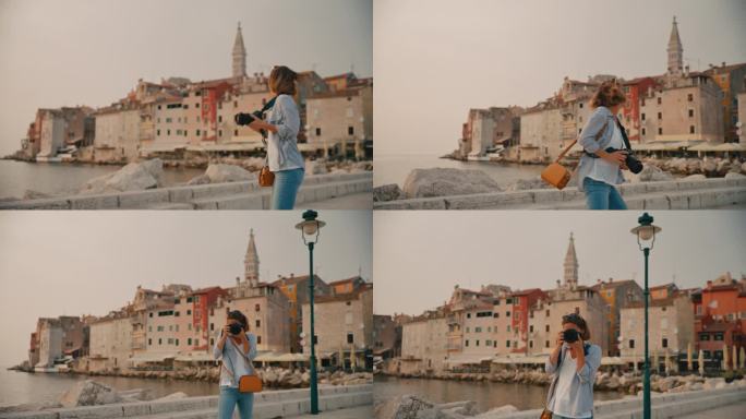 欢快的女游客一边用单反相机对着罗维尼的老城区拍照，一边看着相机