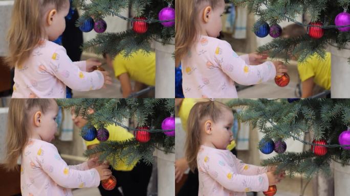 快乐的孩子们围着圣诞树跑，脱下他们的新年玩具。寒假结束后，孩子们和父母把从树上摘下来的新年玩具放进盒