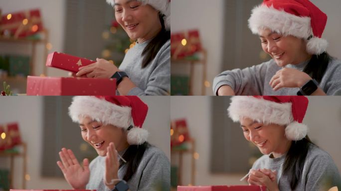 圣诞节当天，亚洲女性在家里办公室打开礼盒，惊喜不已。脸部表情的特写镜头。