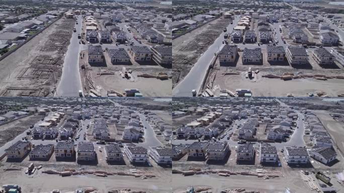 高空无人机拍摄了一个住宅建筑工地，揭示了从裸露地块到有人入住的地块的转变，展示了住宅开发的动态进展