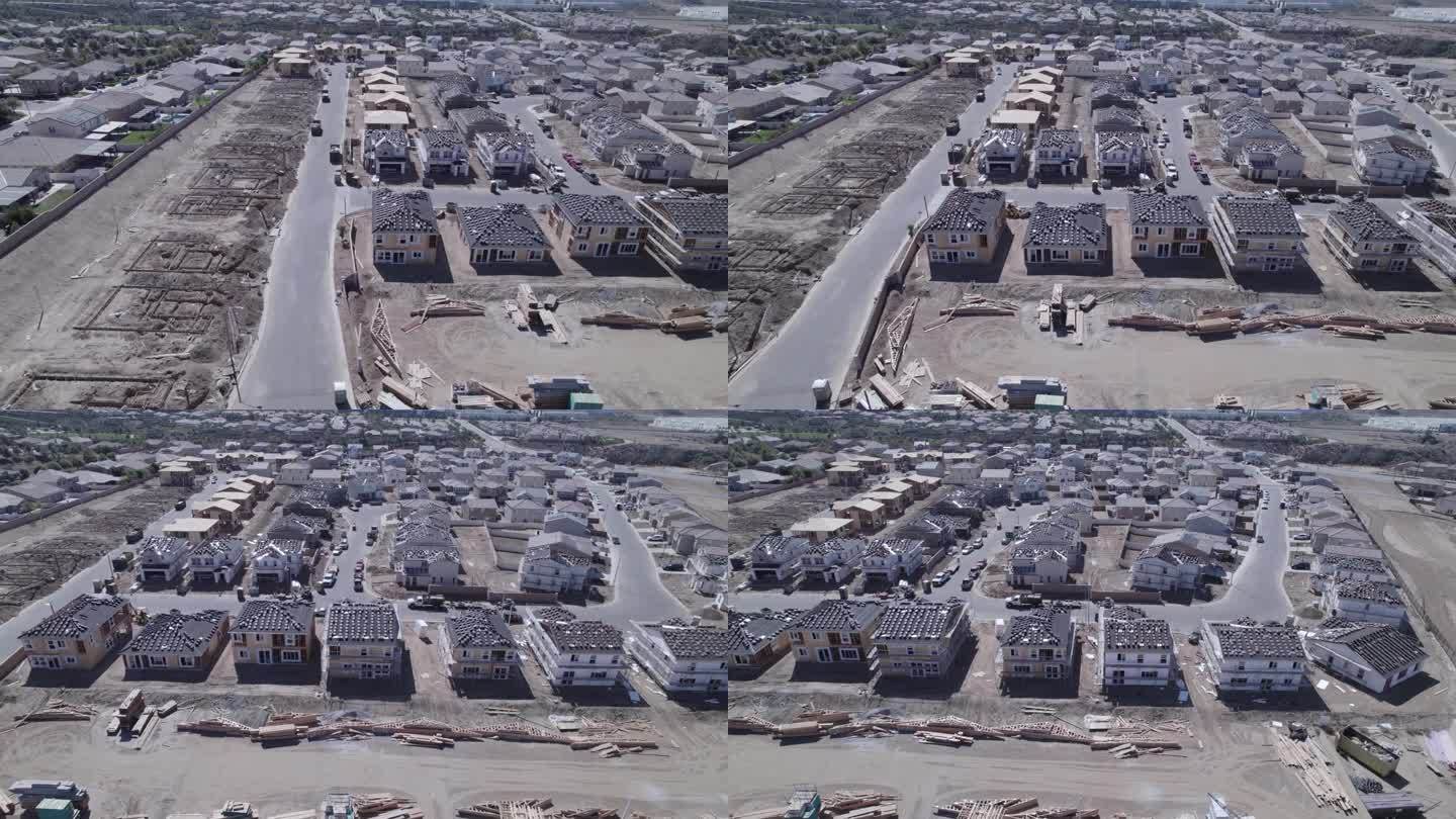 高空无人机拍摄了一个住宅建筑工地，揭示了从裸露地块到有人入住的地块的转变，展示了住宅开发的动态进展