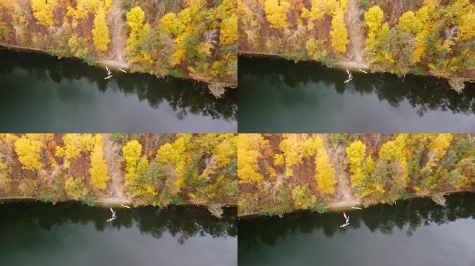 秋天的天空在河上划出弧线，有皮艇和森林