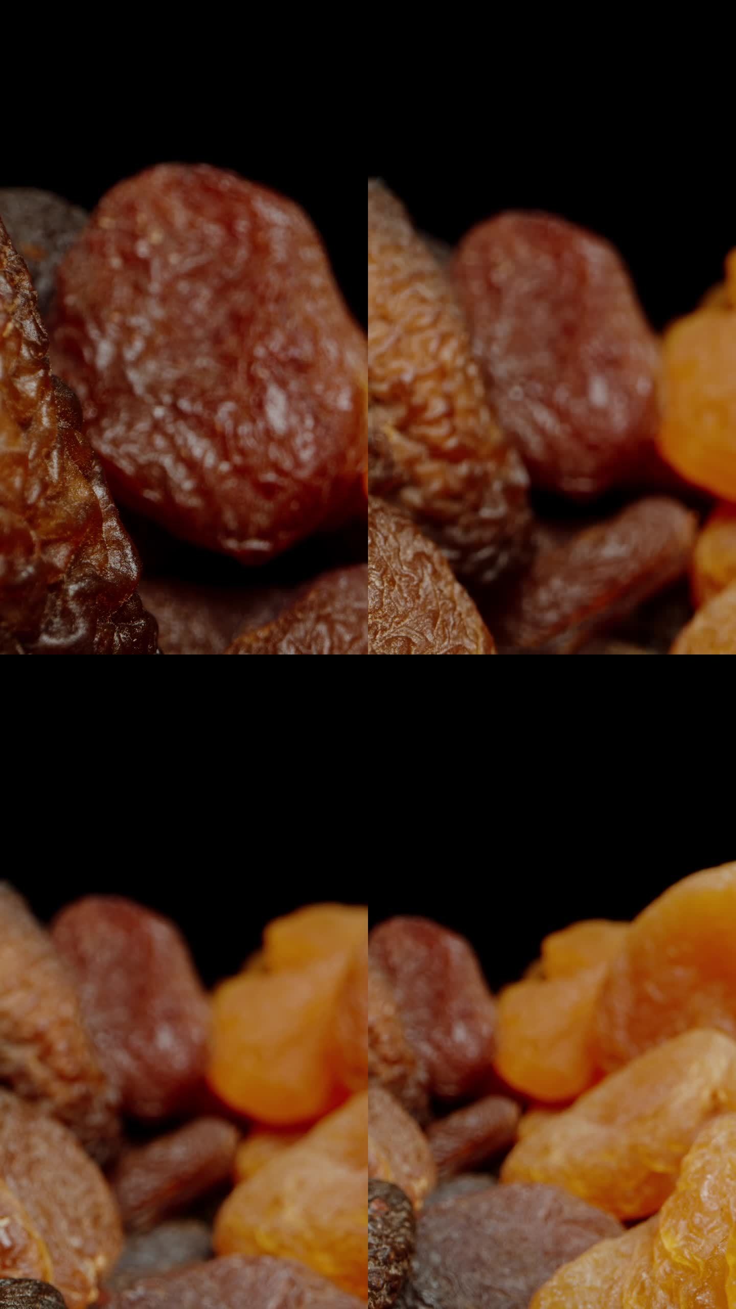 垂直视频。两种干杏，浅色和深色，两种不同的干燥技术。多莉滑块极端特写。