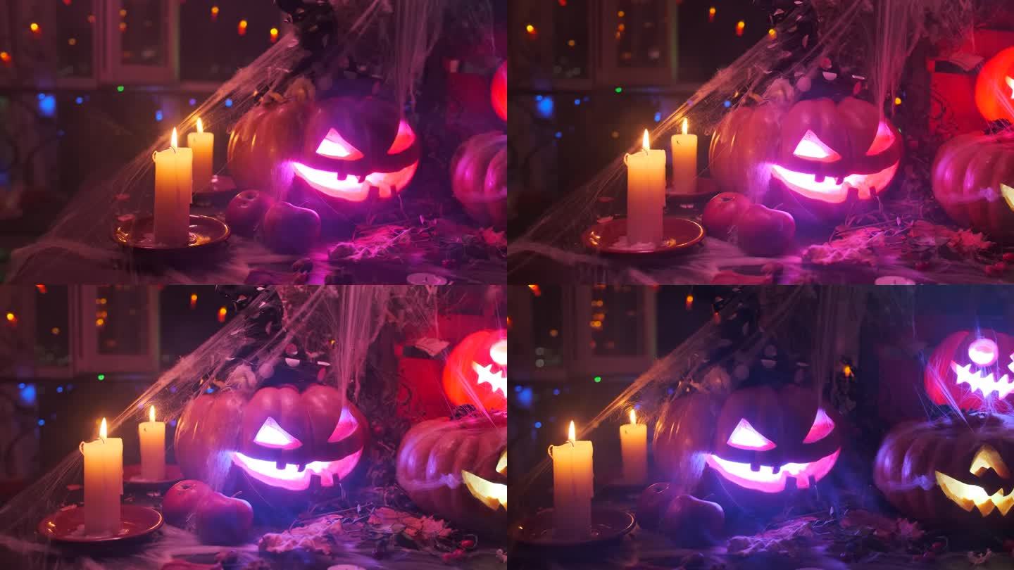 跟踪拍摄诡异的万圣节装饰，杰克灯笼躺在桌子上，蜡烛，蜘蛛网，秋天的苹果，蜘蛛，干树叶
