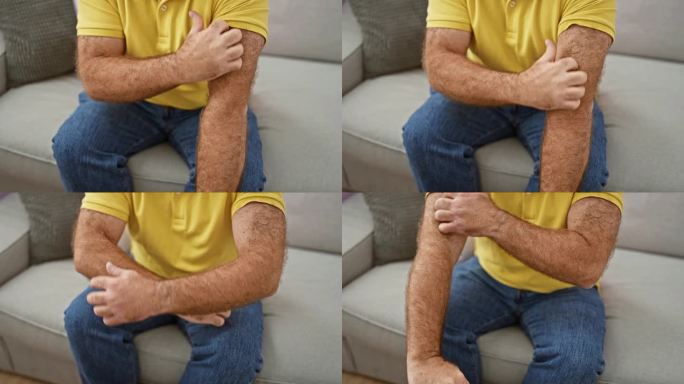 英俊的中年白人男子坐在家里的沙发上，抓挠手臂上发炎的皮肤。瘙痒性皮炎皮疹引起不适。过敏反应需要保健。