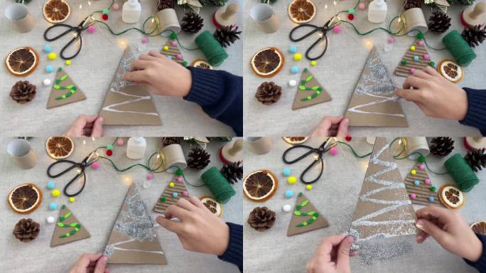 孩子们用胶水把棕色硬纸板盖在圣诞树上，然后涂上银色的亮片。圣诞节用自己的双手装饰圣诞树。冬天的装饰。