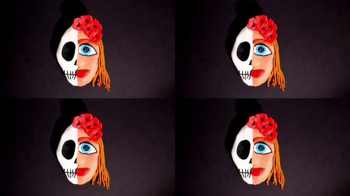 定格动画。一个女人的橡皮泥头被分成头骨，另一边是带着红色王冠的花头发。