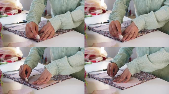 女设计师用纸图案在花织物上做肥皂记号