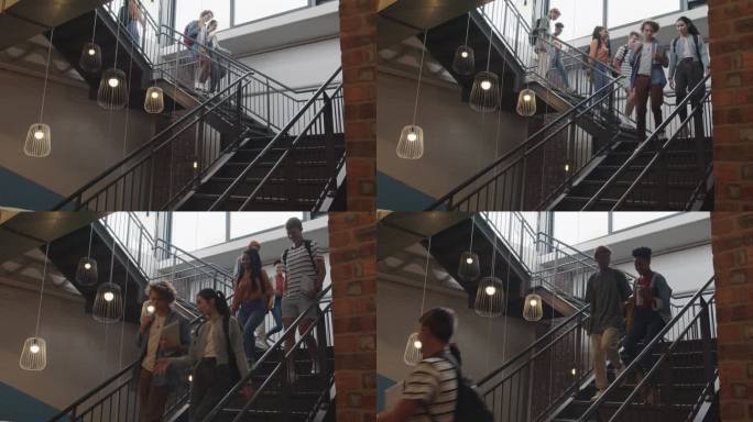 学生们在课间走下楼梯时微笑着交谈