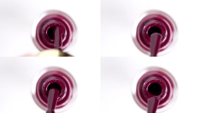 暗粉色凝胶指甲油，红色紫胶UV凝胶瓶，刷，慢动作。修指甲的概念。