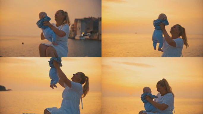 克罗地亚罗维尼老城，夕阳西下，一位兴高采烈的母亲坐在海边的岩石上抱着刚出生的婴儿