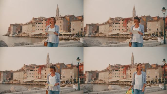 快乐的女游客在克罗地亚罗维尼市海上探险时阅读路线图