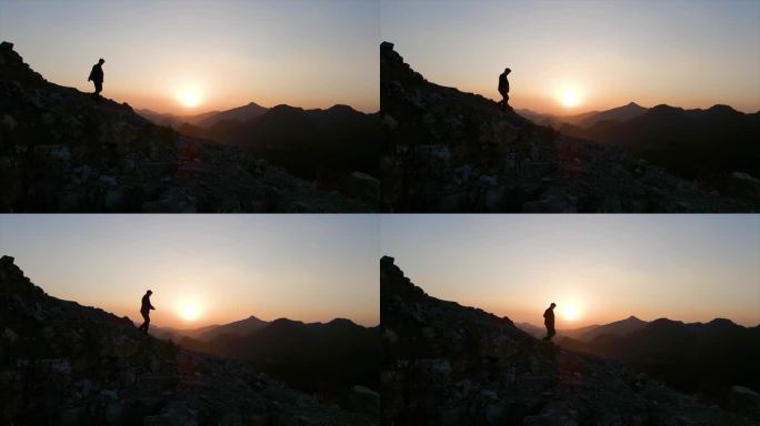 一个人从山顶漫步走下山人物剪影夕阳西下