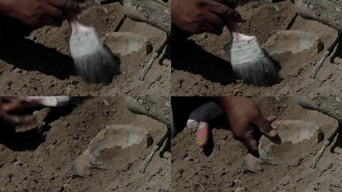 考古发掘，考古学家在土壤中挖掘出一个古老的粘土工艺品。关闭了。