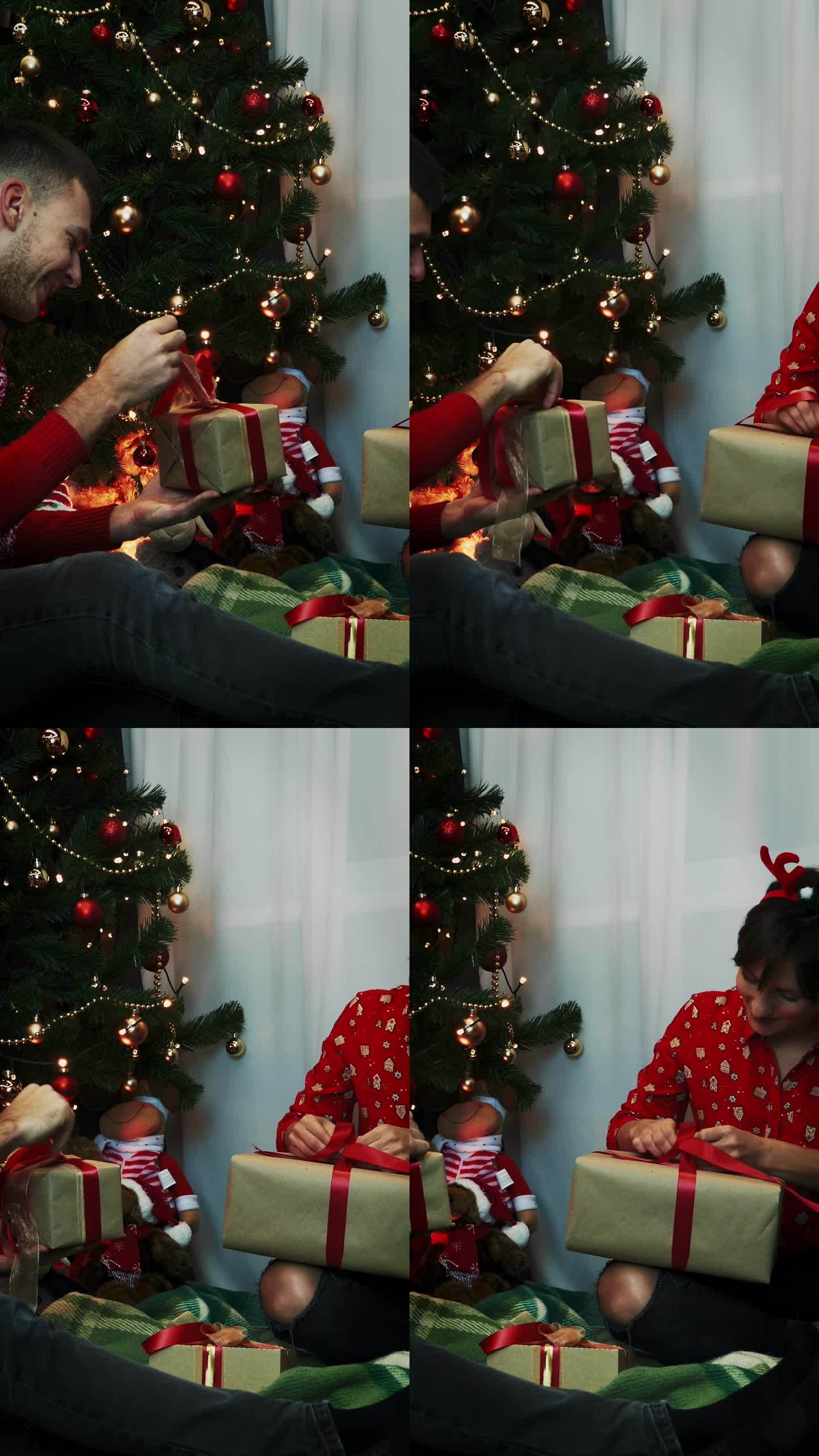 家人在家里庆祝圣诞节，打开礼盒里的礼物。垂直视频