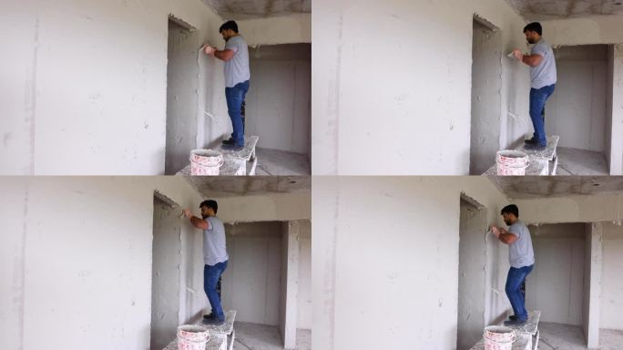 拉丁美洲的建筑工人在建筑工地给墙壁抹灰泥