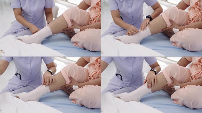 一名住院的亚洲老年病人的特写照片。一名护士正在照顾一名病人受伤的腿部绷带。