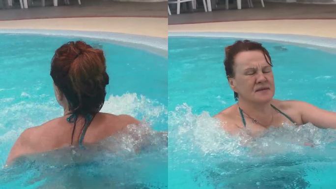 一位女士正在室外游泳池享受游泳，并在水下按摩景点享受按摩。