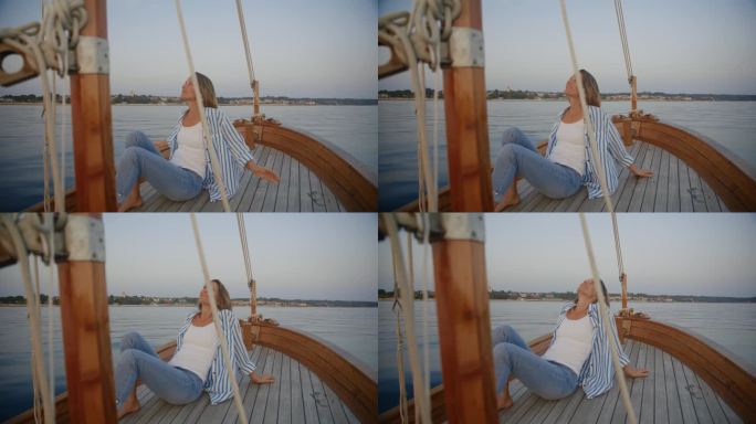 漂浮的宁静:一个女人享受着微风，在帆船的甲板上享受着这一刻