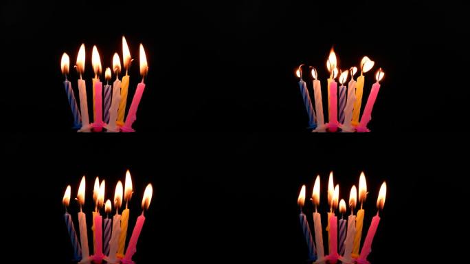 蛋糕生日蜡烛燃烧在黑色的背景。