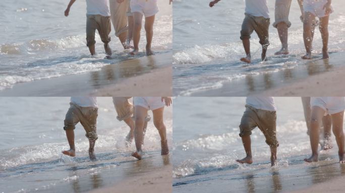 男女小孩在海边玩水奔跑打湿了裤脚