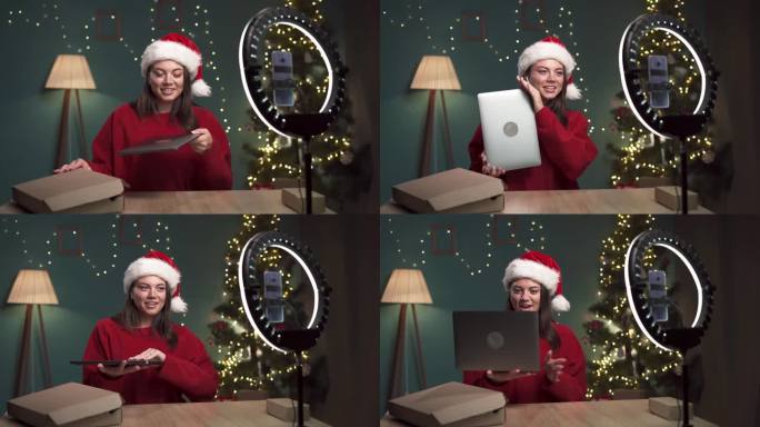 女博主在圣诞节在家拆笔记本电脑的同时，用现代智能手机录制视频内容。影响者对现代小工具进行审查。