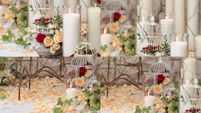 优雅的婚礼装饰，蜡烛，玫瑰花瓣，鸟笼，设置在过道上。浪漫的婚礼场地装饰。插花增加了仪式感。梦幻般的婚