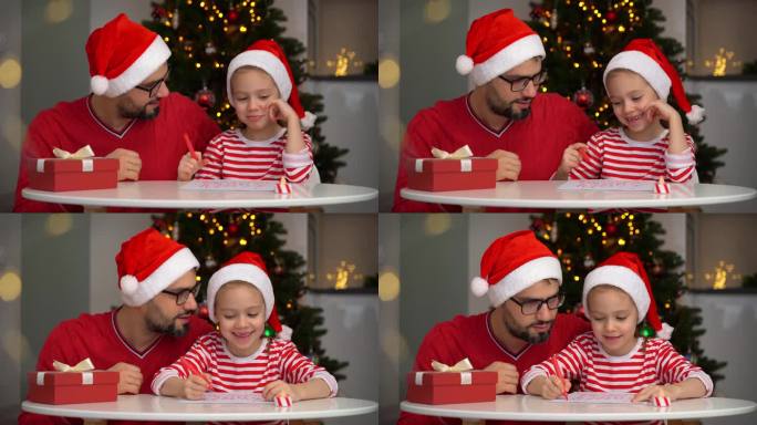 父亲和女儿在圣诞树的背景下给圣诞老人写信
