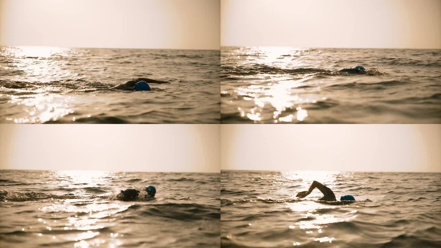 日落时女子在海中游泳的锁定镜头