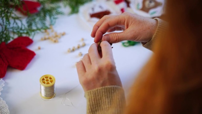 一个狡猾的女人制作圣诞软玩具在网上商店出售。女性创意，经营着自己的手工自由职业。新年玩具出售作为礼物