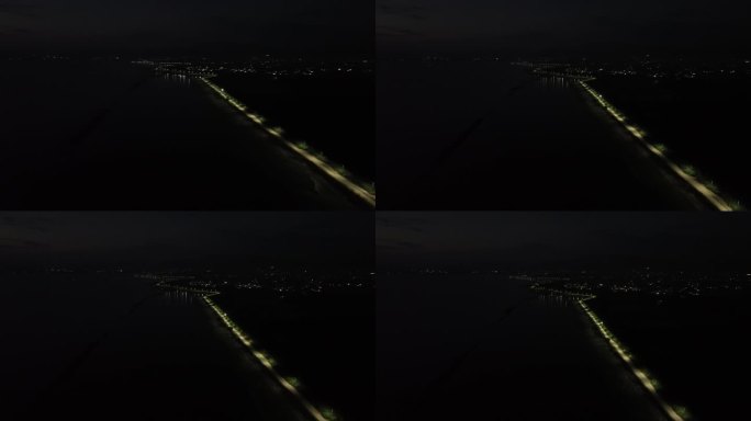 夜间无人街道的鸟瞰图。鸟瞰印尼哥伦塔洛林波托湖边缘的一排路灯