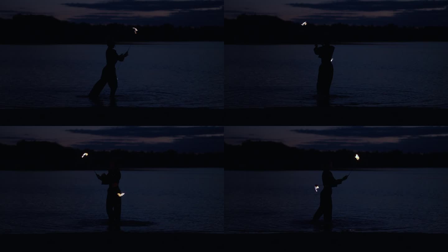一个女人在河边用火表演，黑暗中神秘的女性剪影