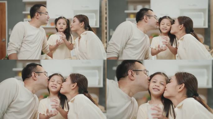 亚洲父母分享衷心的时刻，亲吻他们笑着的女儿:捕捉到真正的家庭之爱。