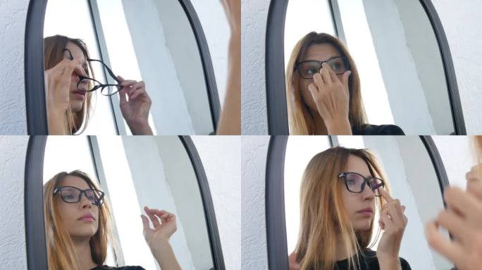 一个年轻漂亮的女人在镜子前试黑框眼镜