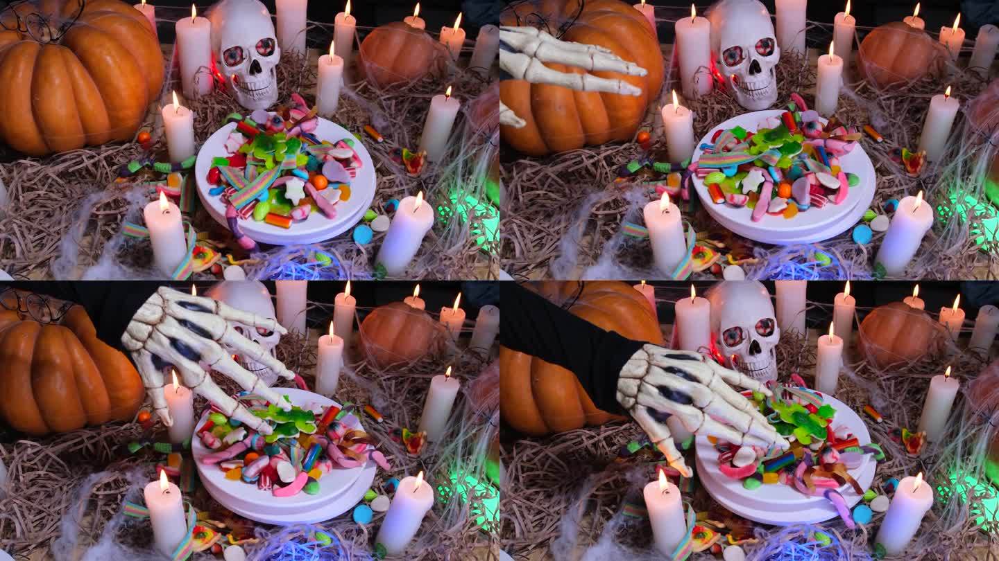 令人毛骨悚然的骷髅手和一堆糖果在蜡烛、头骨和大南瓜之间旋转