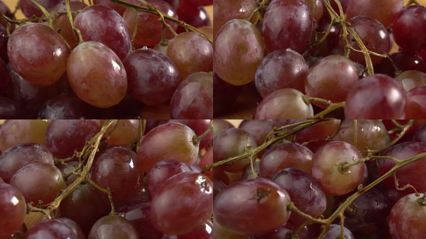 葡萄特写，概念酿酒，葡萄酒生产，葡萄品种。新鲜的一串串红色或粉红色的葡萄作为背景旋转